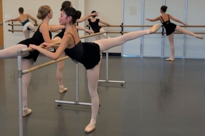 Dancers on pointe at the barre for an audition.