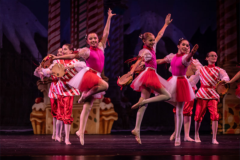 Dancers jumping as peppermints in The Nutcracker.