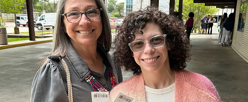 A mom and daughter holding tickets to see ballet performance.