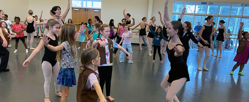 Brownies and advanced dancers learning a dance combination in studio