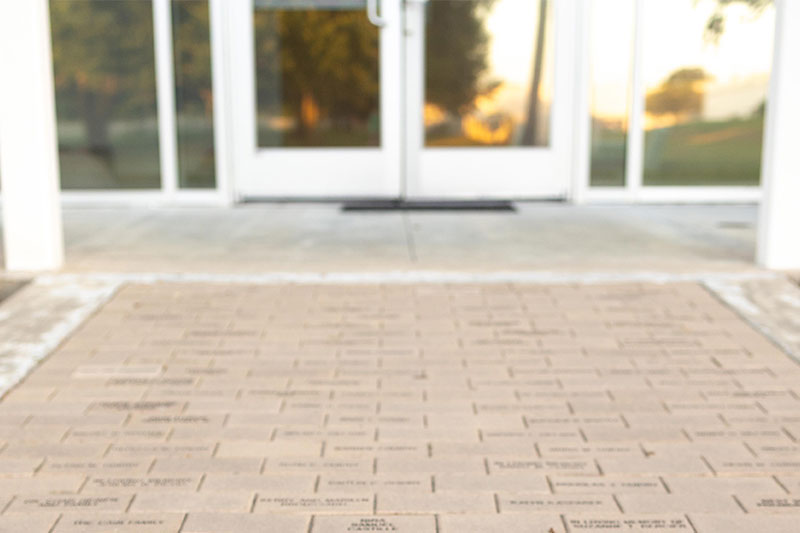 engraved bricks leading to doors of studio