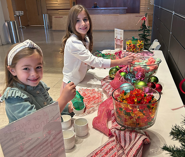 2 girls get candy at the Nutcracker Tea
